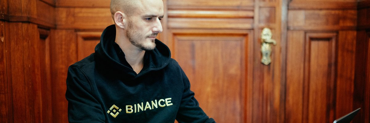Nikolai Søndergaard working on laptop in Binance hoodie